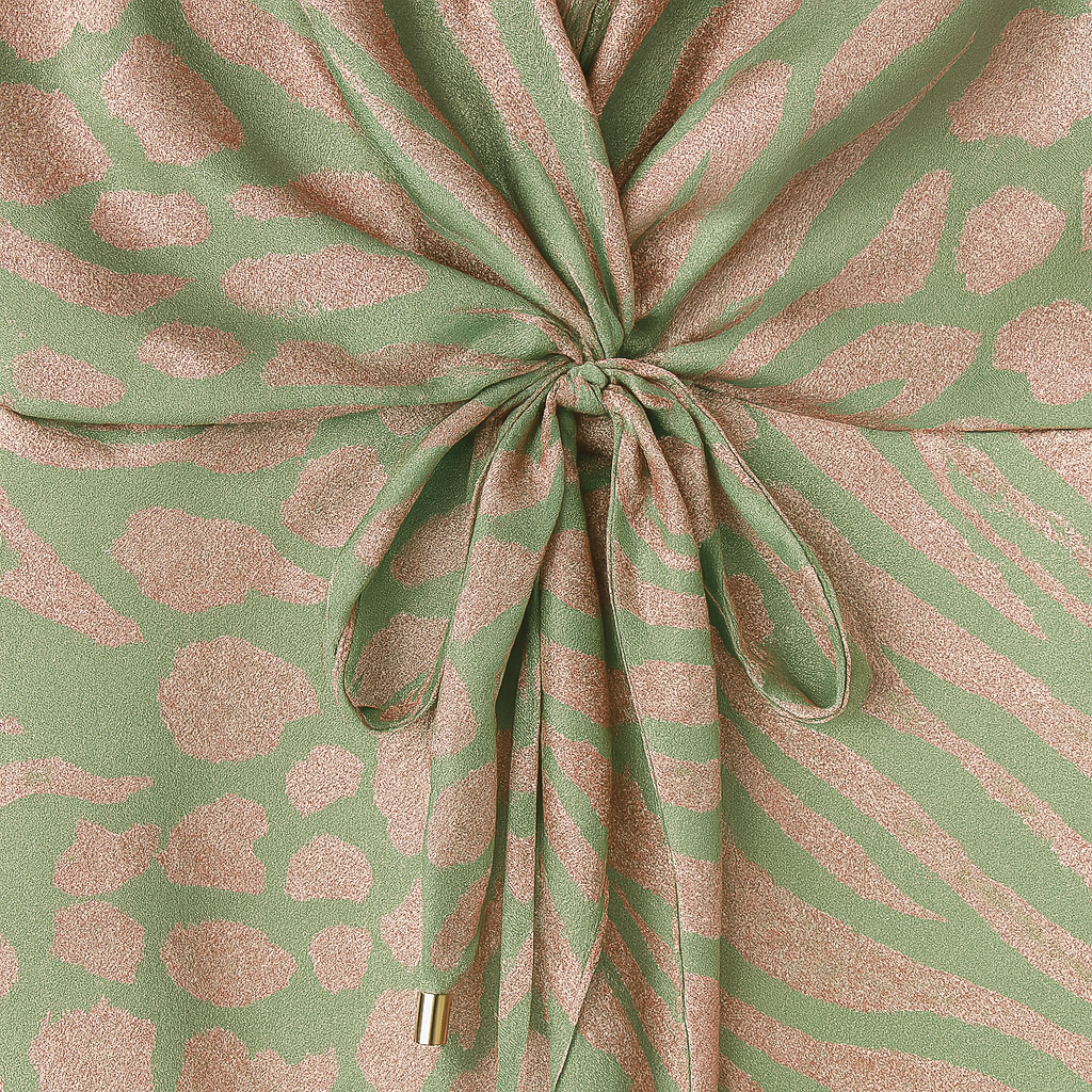 Satin wrap-style maxi dress in sage green with metallic pink abstract print, deep V-neckline, short sleeves, and draped waist detail.