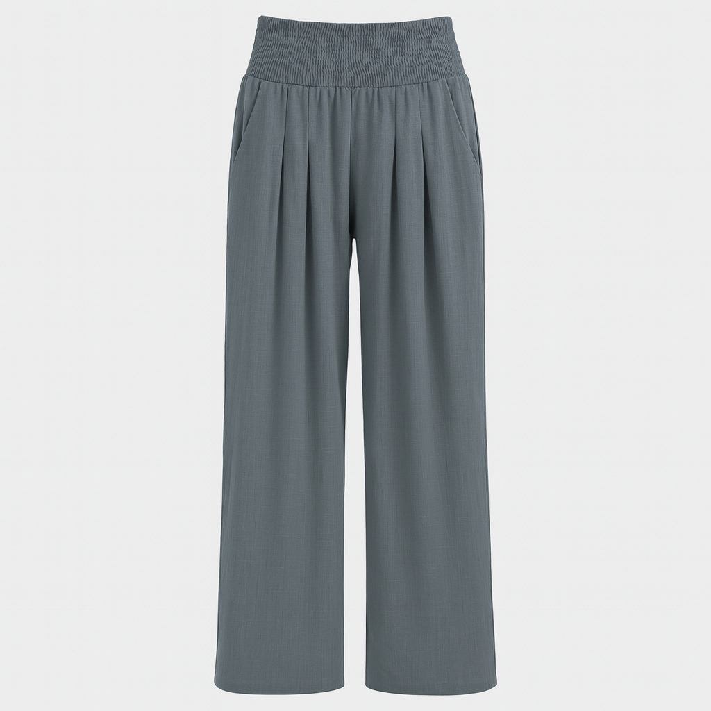 Wide-leg linen-blend pants with pleated front and smocked high waist, styled for relaxed summer beachwear