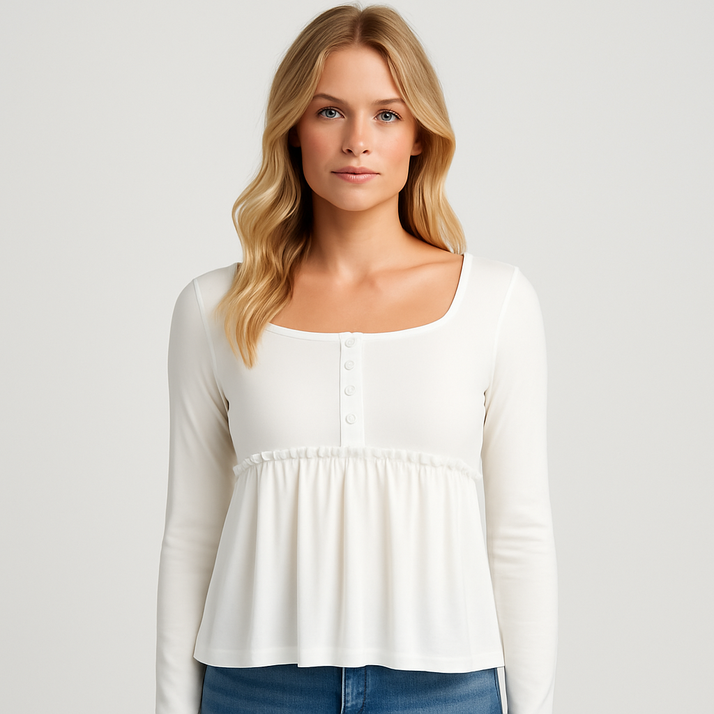 A white babydoll-style long sleeve top with a square neckline, button-front detailing, and ruffle trim at the empire waist.