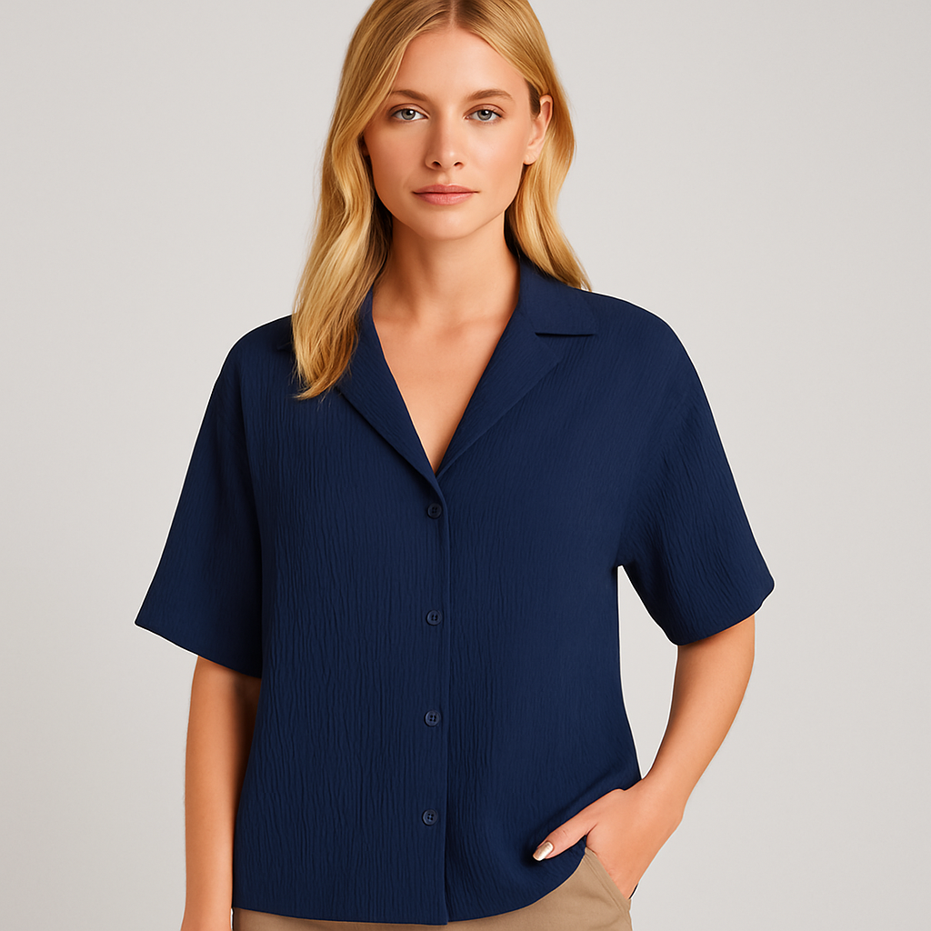 Navy blue relaxed-fit shirt with short sleeves, button-down front, and open collar.