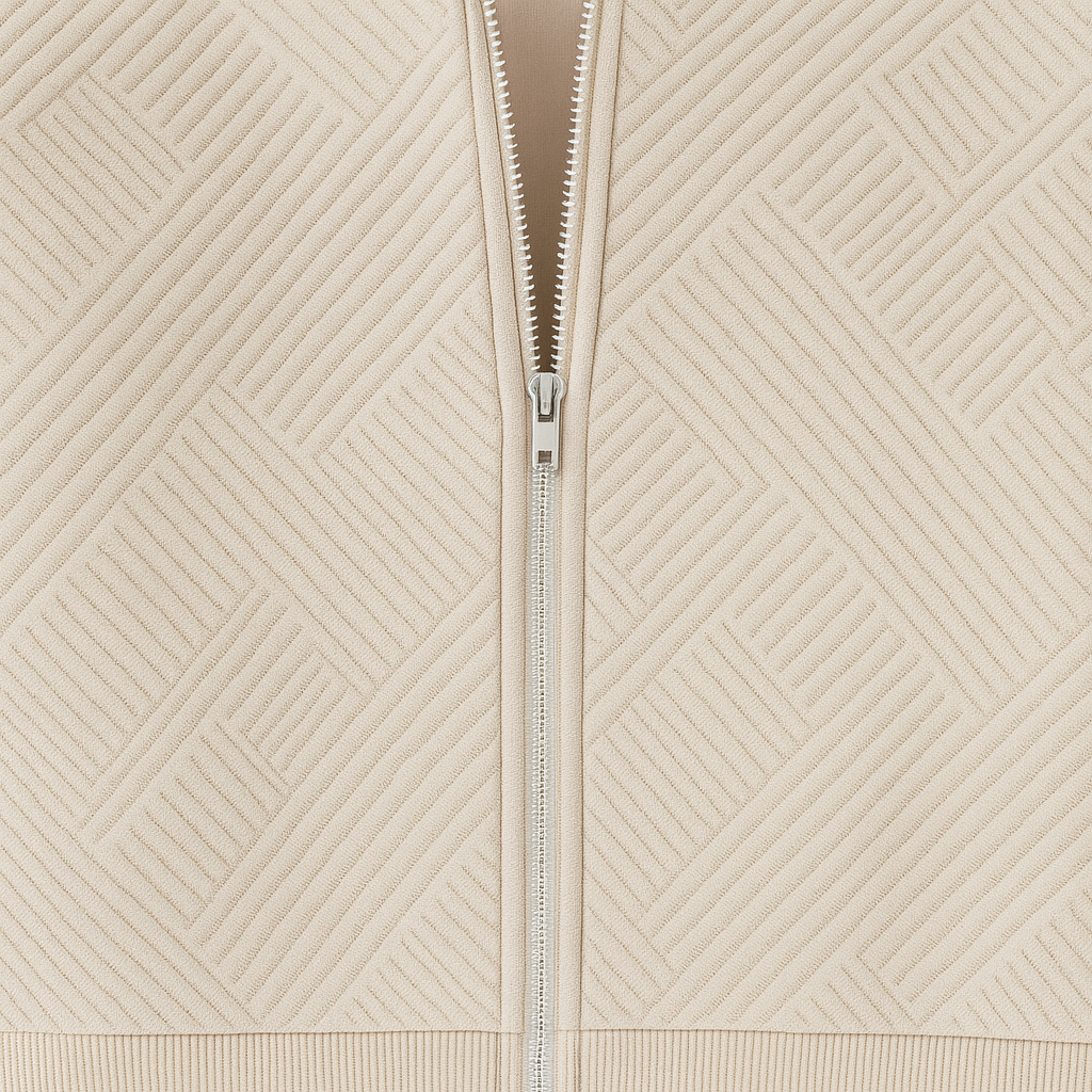 Zipper-front jacket with a geometric textured design, ribbed cuffs and hem, and a fitted silhouette.