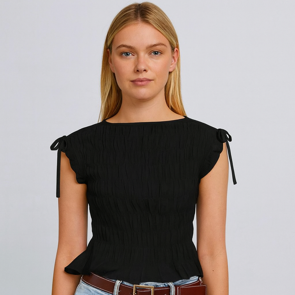 a black ruched top with bow-tie cap sleeves and a peplum hem