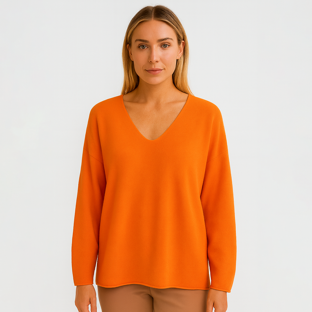 Oversized knit sweater with deep V-neck and long sleeves.