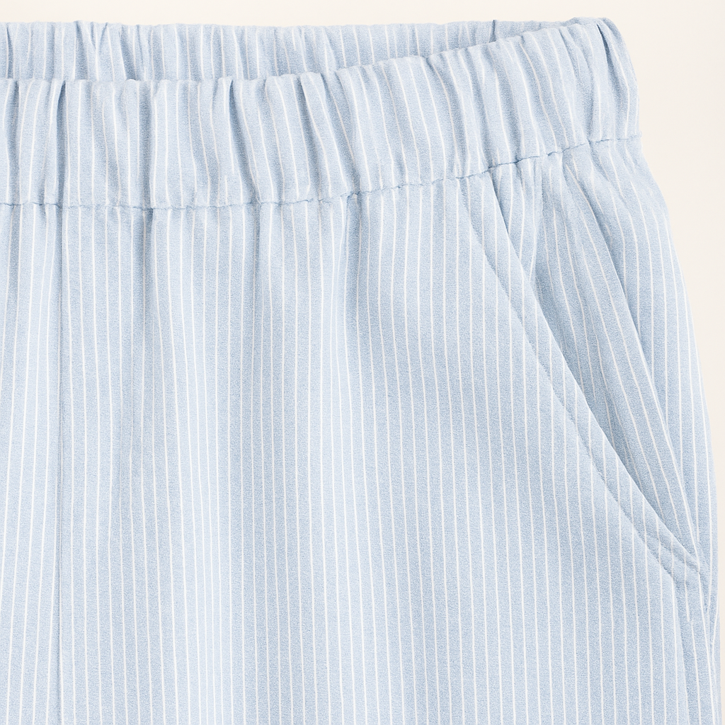 Relaxed cotton pants with elastic waistband and subtle pinstripe texture.