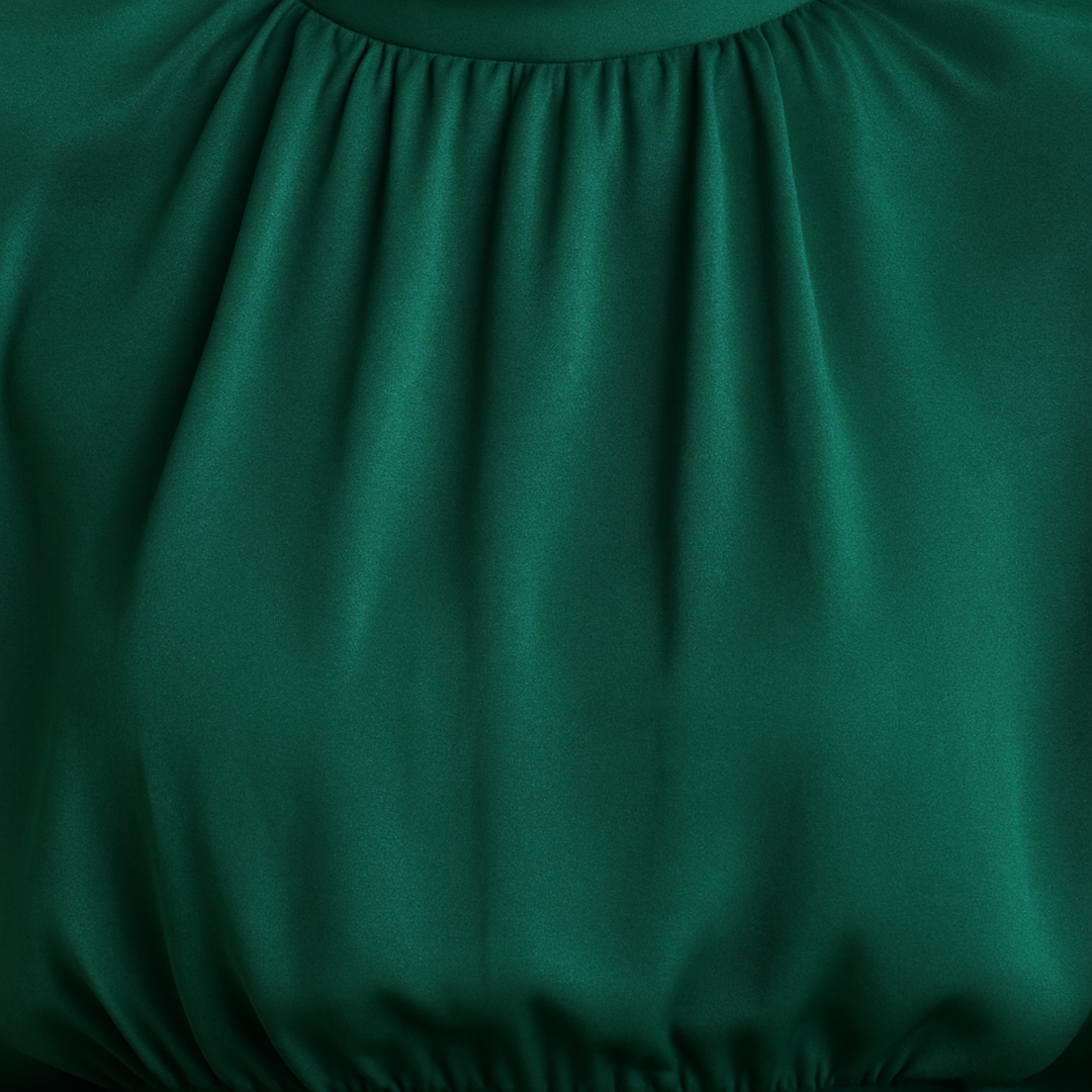 High-neck jumpsuit with wide-leg pants, relaxed fit bodice, and cape-style sleeves.