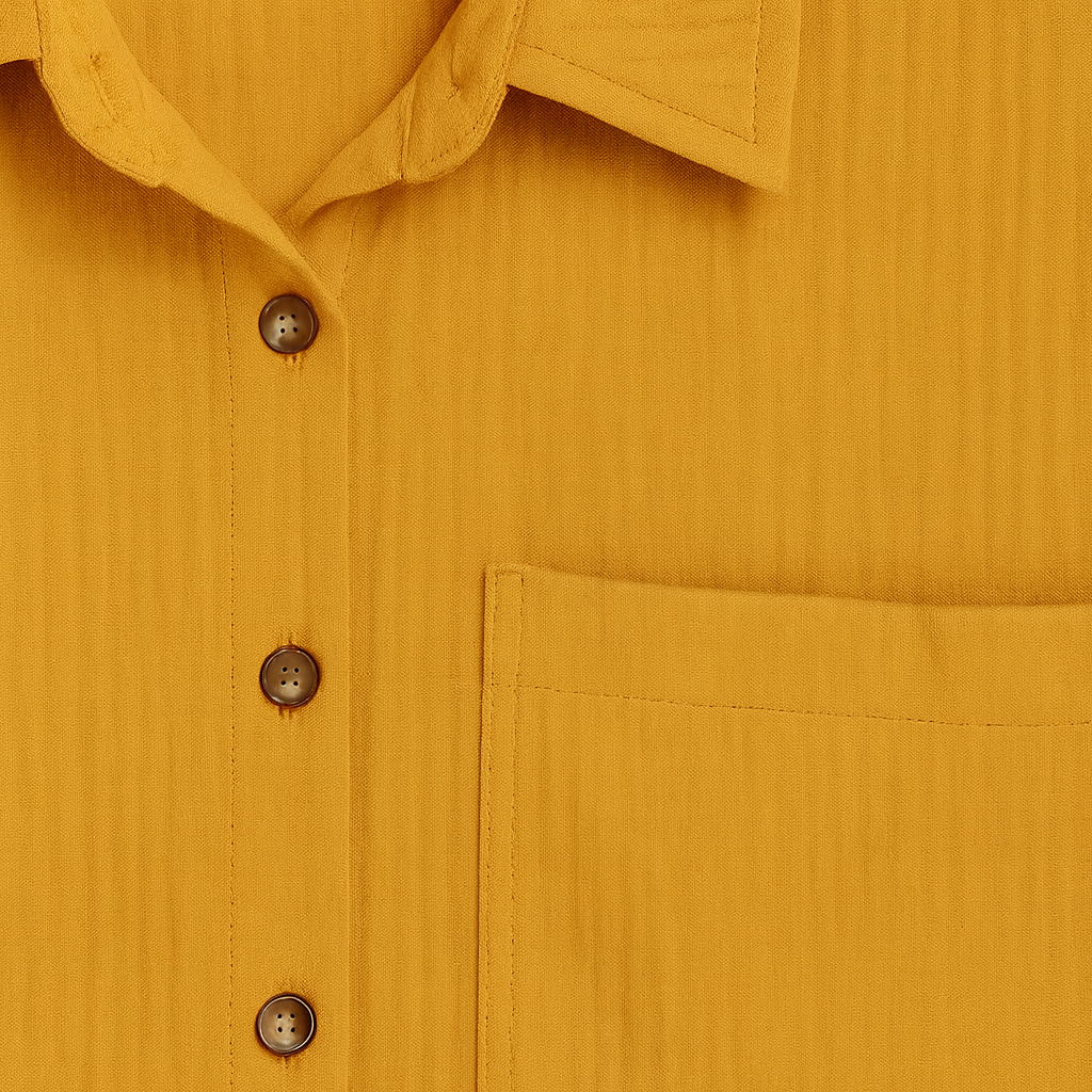 Long-sleeve button-up shirt with pointed collar, front chest pocket, and rolled cuffs.