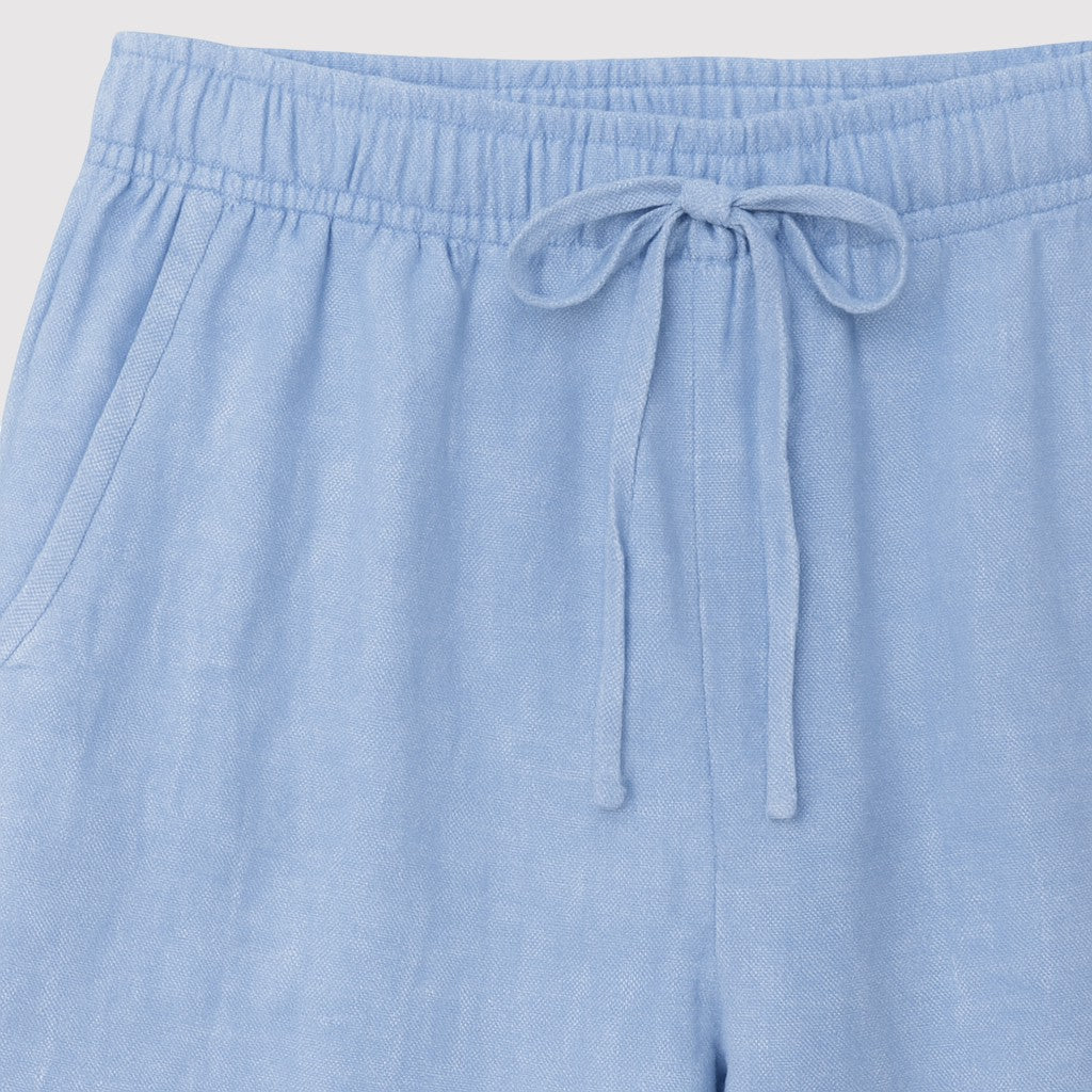 Relaxed linen drawstring pants with straight-leg fit and elastic waistband, styled for a casual everyday look