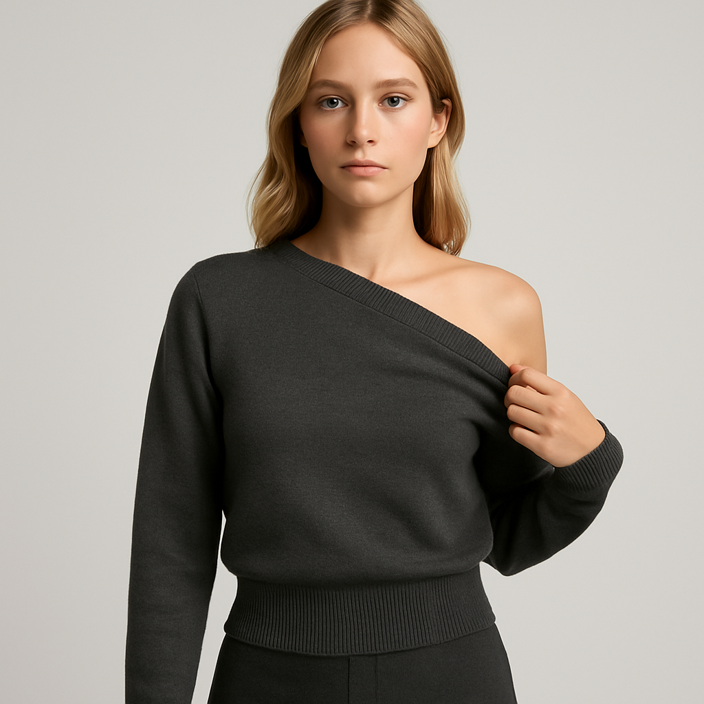 Charcoal grey off shoulder knit sweater with ribbed hem and cuffs, styled with a dark skirt for an edgy casual look