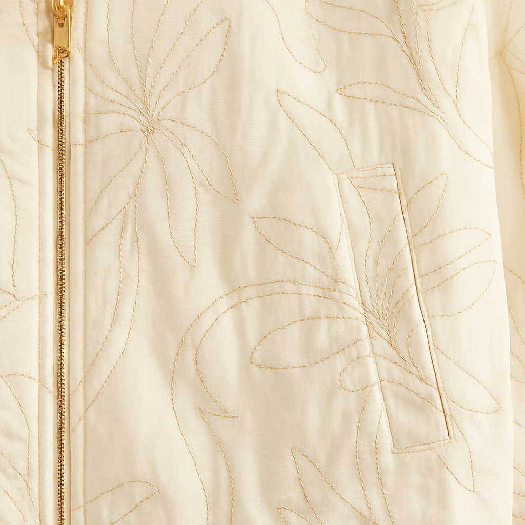 A structured jacket with long sleeves, a round neckline, gold-tone buttons, and faux leather trim.