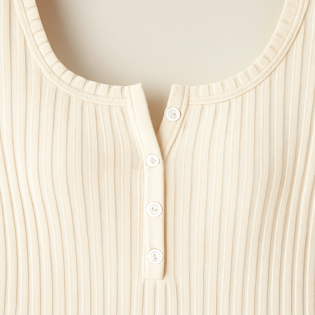 Cream ribbed knit long sleeve top with square neckline and button front detail, styled with white textured bottoms