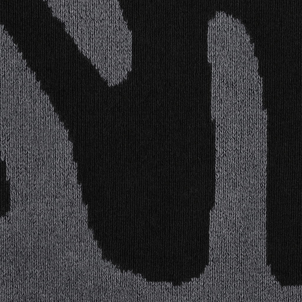 Knit sweater with bold abstract pattern, crew neckline, and ribbed cuffs designed for modern casual wear