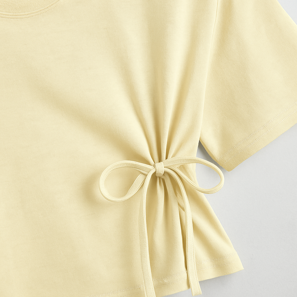 cream cropped top with short sleeves and a tie-front detail at the waist