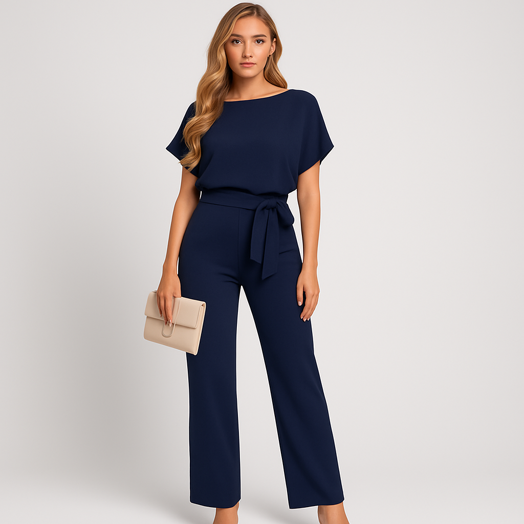 A short-sleeve jumpsuit featuring a boat neckline, a wide fabric belt tied in a bow at the waist, and straight-leg pants for a modern, minimalist silhouette.