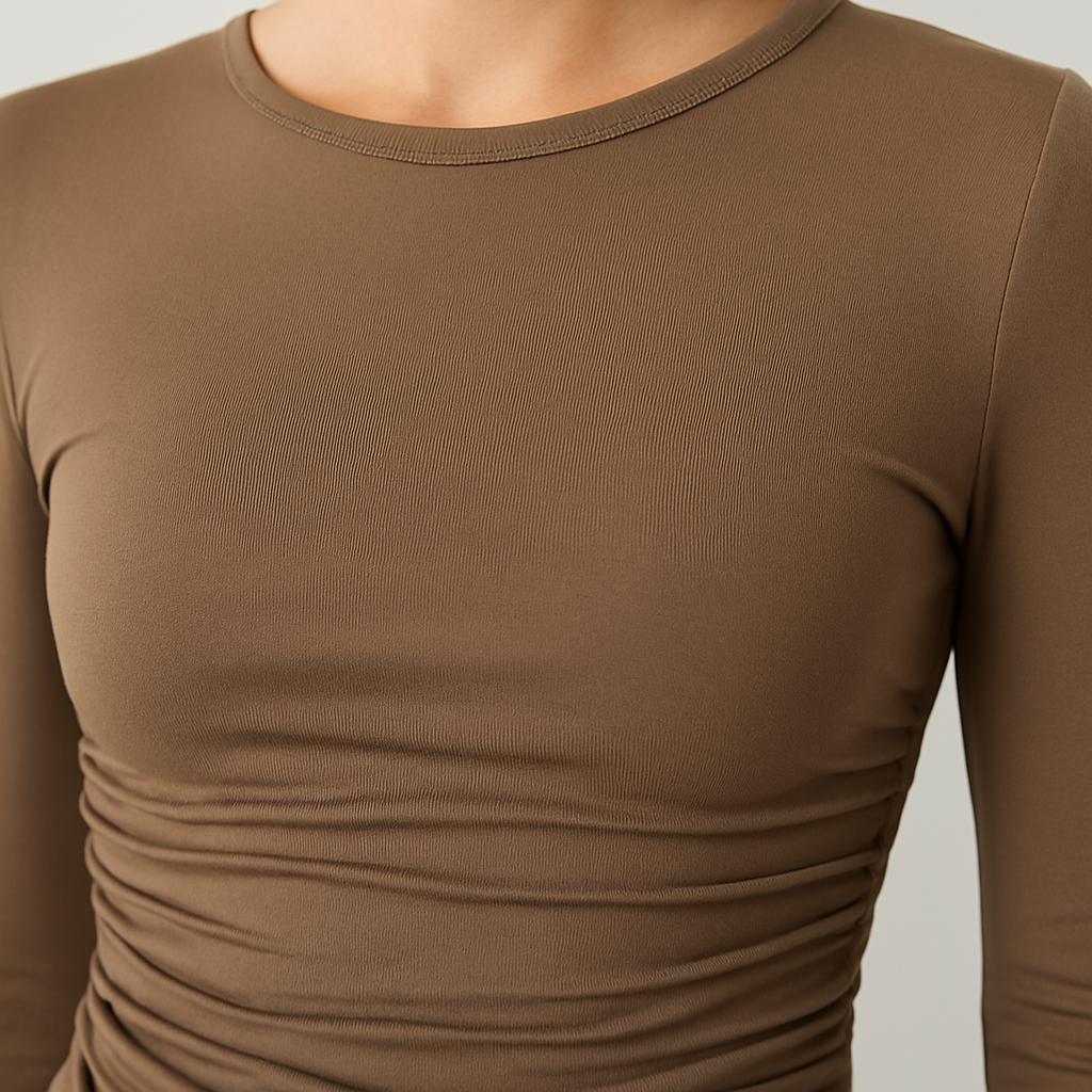 Brown ruched long sleeve fitted top with crew neckline, styled with light wash denim jeans