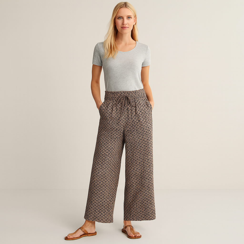 Wide-leg patterned pants with elastic waistband and drawstring tie.