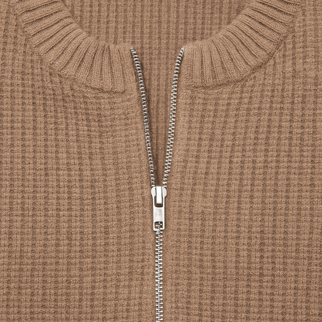 A taupe ribbed knit zip-up cardigan