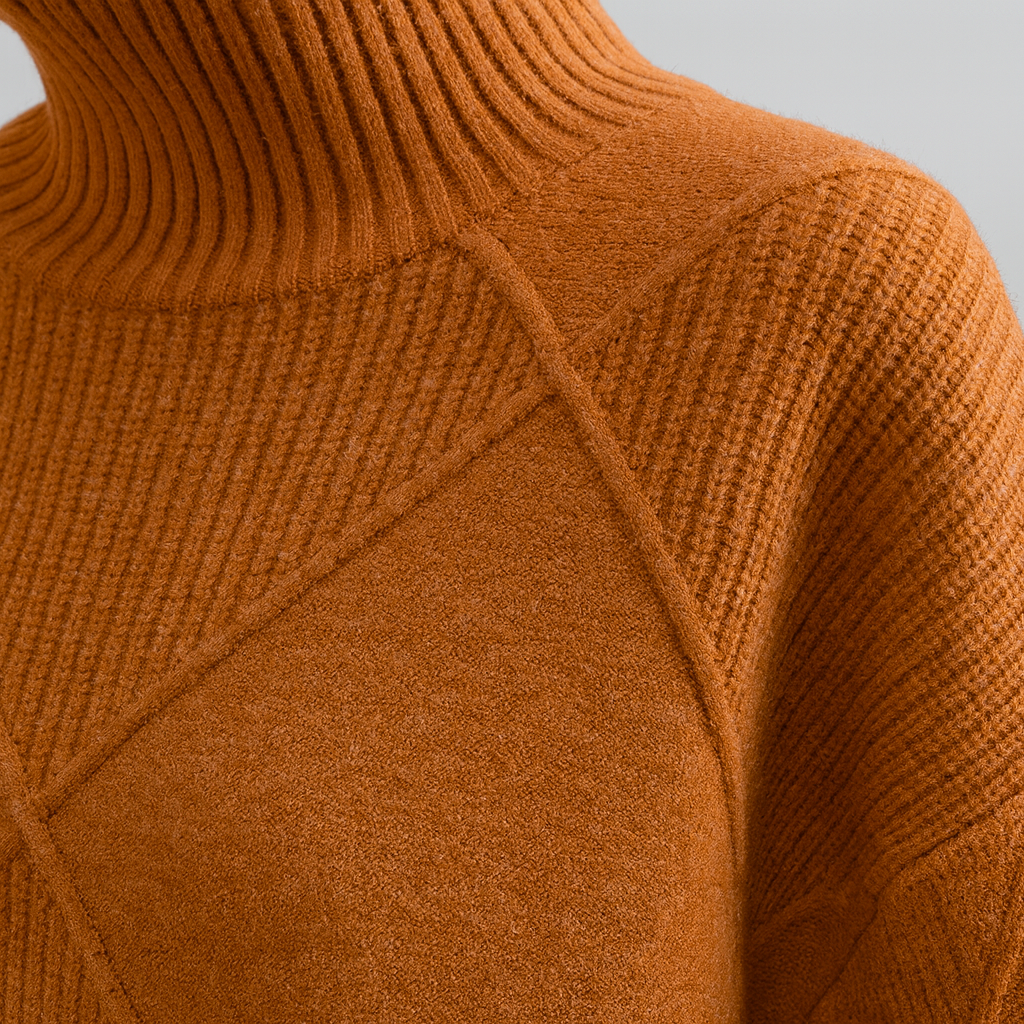 A turtleneck sweater with a large diamond-knit pattern, ribbed collar, cuffs, and hem, featuring long sleeves and a relaxed fit.