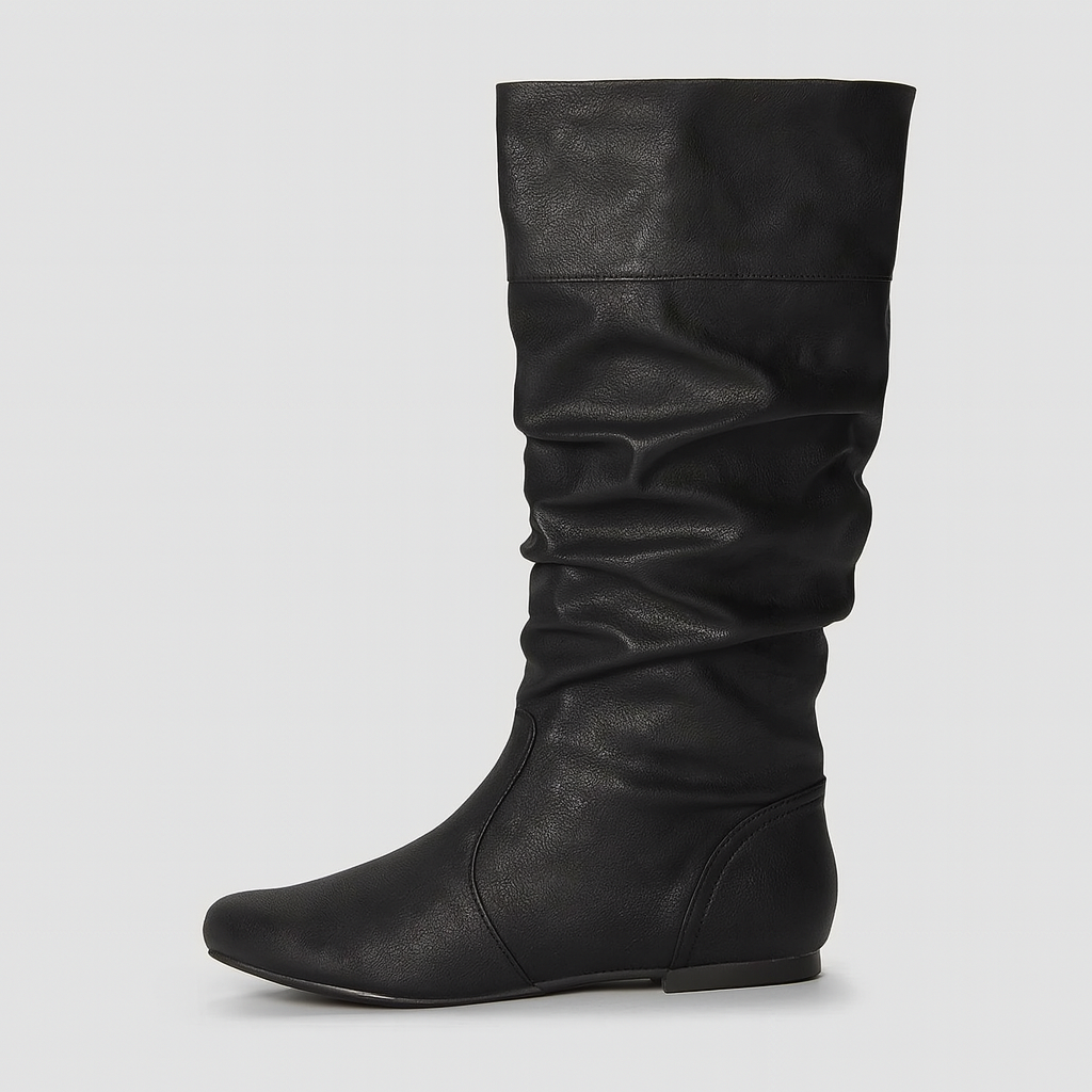 Faux leather slouch knee-high boots with pointed toe and flat sole, styled for casual everyday wear.