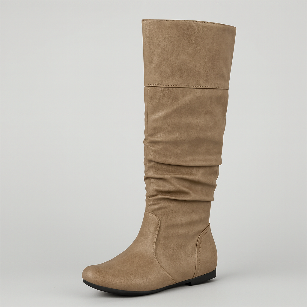 Faux leather slouch knee-high boots with pointed toe and flat sole, styled for casual everyday wear.