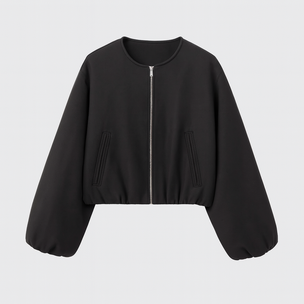 A zip-up jacket featuring a minimalist round neckline, dropped shoulders, and oversized balloon sleeves. The design includes front slit pockets and a gathered hem, creating a relaxed, casual silhouette perfect for layering in cool weather.