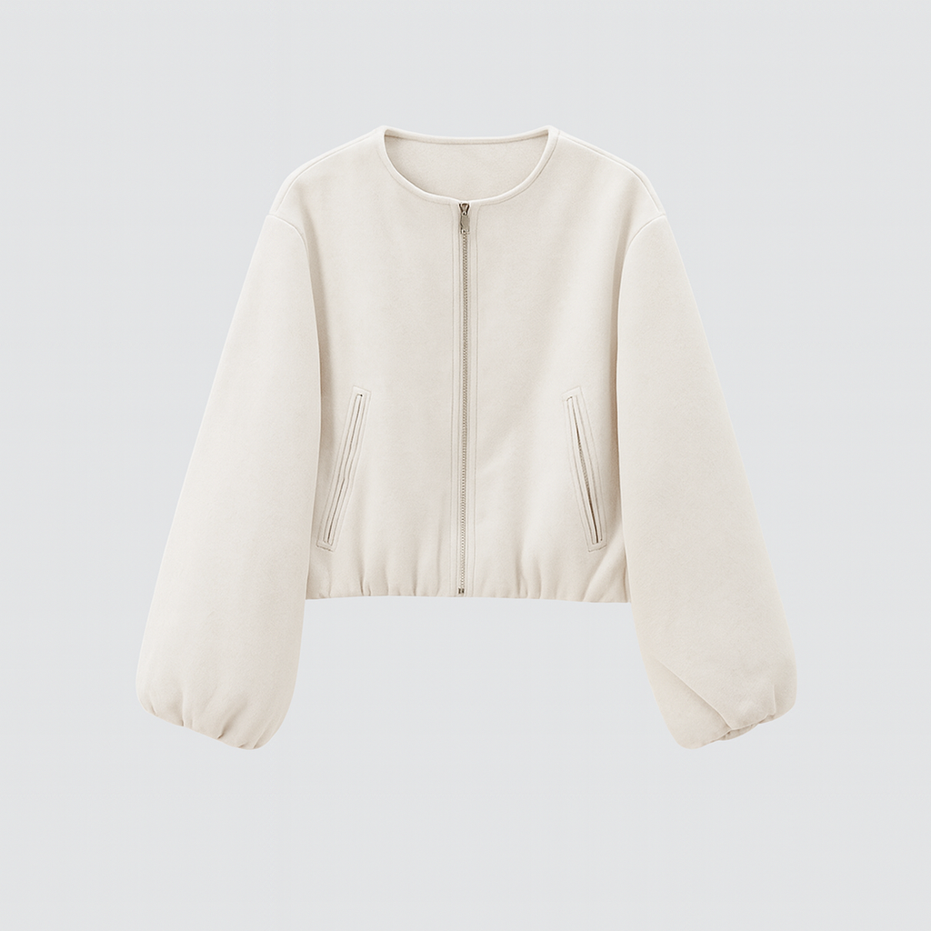 A zip-up jacket featuring a minimalist round neckline, dropped shoulders, and oversized balloon sleeves. The design includes front slit pockets and a gathered hem, creating a relaxed, casual silhouette perfect for layering in cool weather.