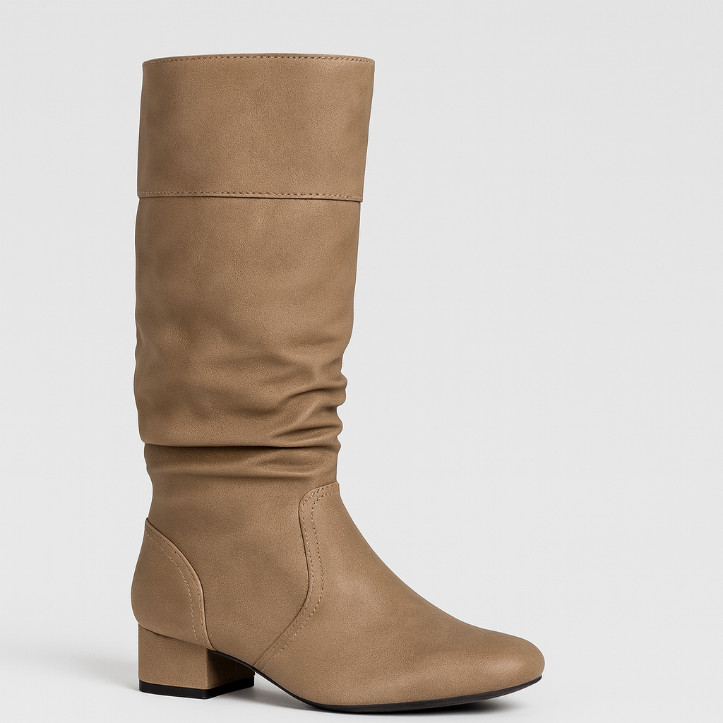A sleek mid-calf boot with a slouchy leather design and rounded toe. The flat sole provides comfort and ease for everyday wear, while the soft, gathered texture adds a touch of casual sophistication to the minimalist silhouette.