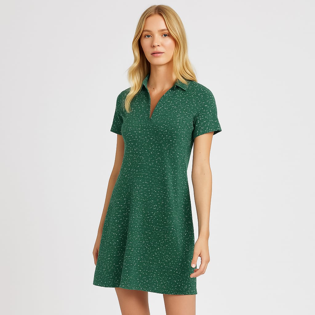 A short-sleeve, above-knee dress with a collared neckline, V-shaped opening at the chest, and an all-over small dotted print.