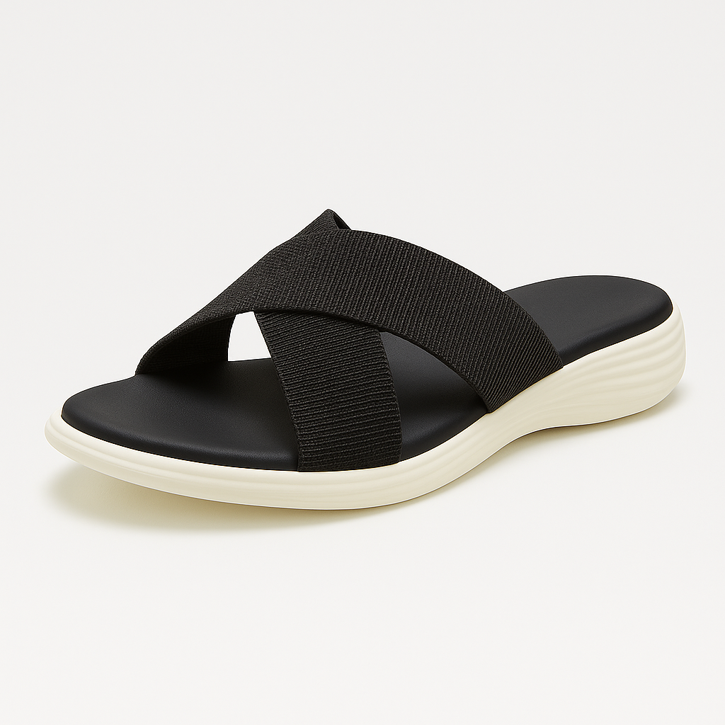 A slip-on sandal with wide crisscross straps over the front, cushioned footbed, and a contoured sole with a wavy texture.