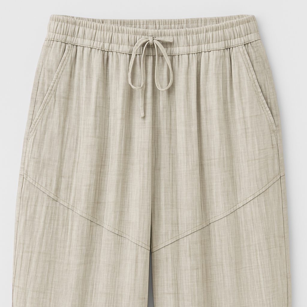 Light beige textured wide-leg lounge pants with drawstring waist and cinched hems, styled casually for relaxed wear.