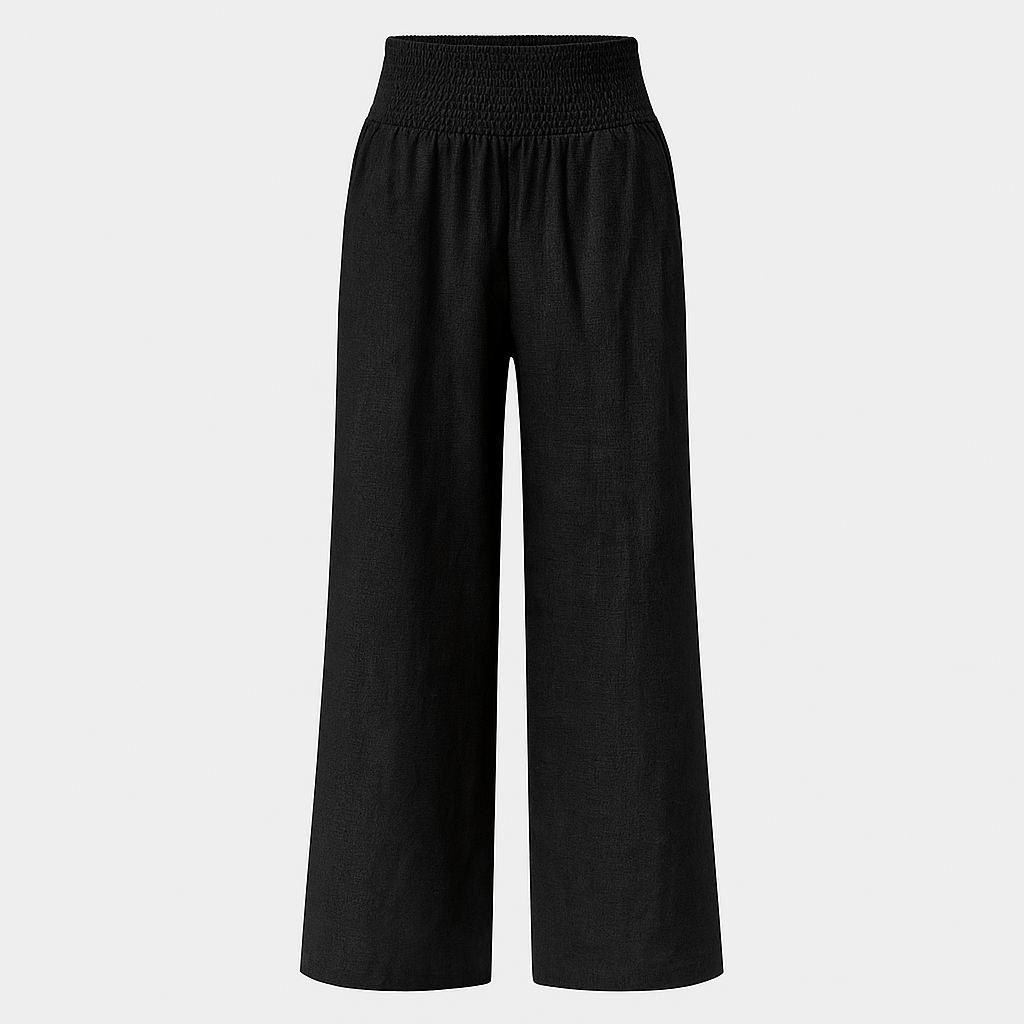 Wide-leg linen-blend pants with pleated front and smocked high waist, styled for relaxed summer beachwear