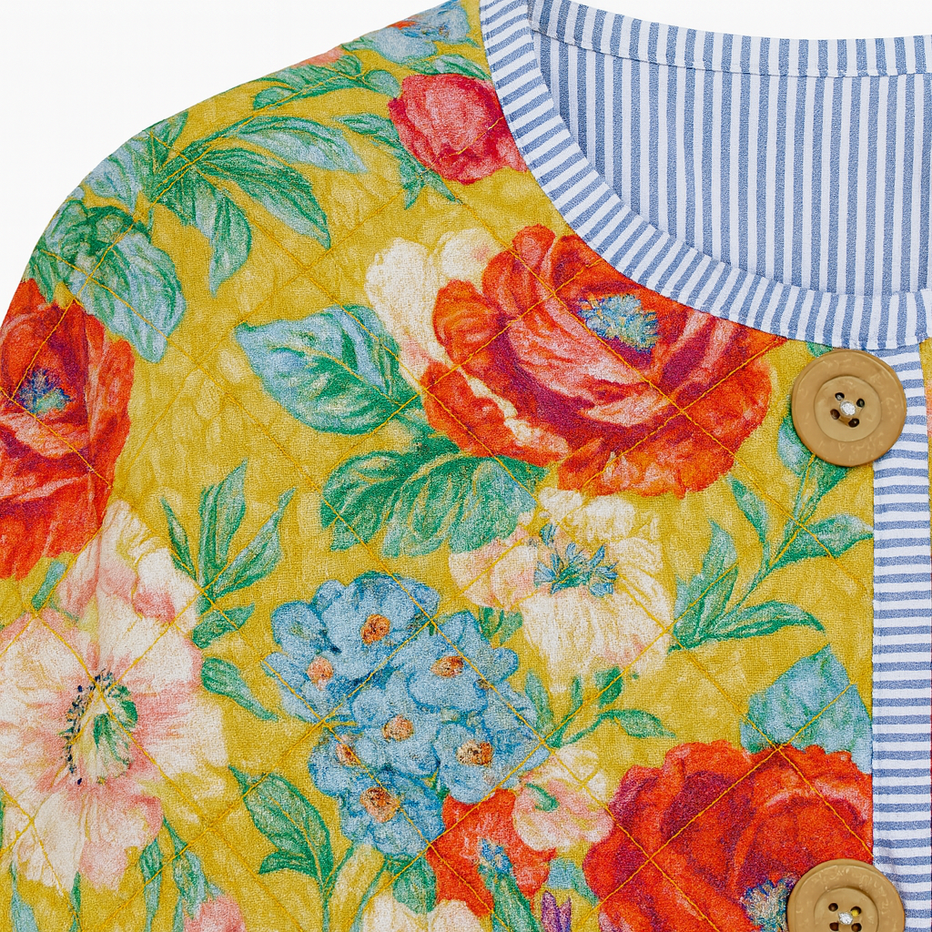 Long-sleeve quilted jacket with a round neckline, open front, and front patch pockets.