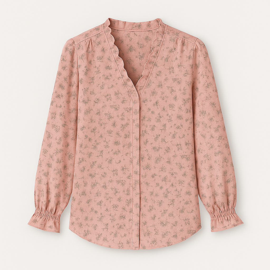 Blouse with V-neckline and ruffle trim along neckline and cuffs.