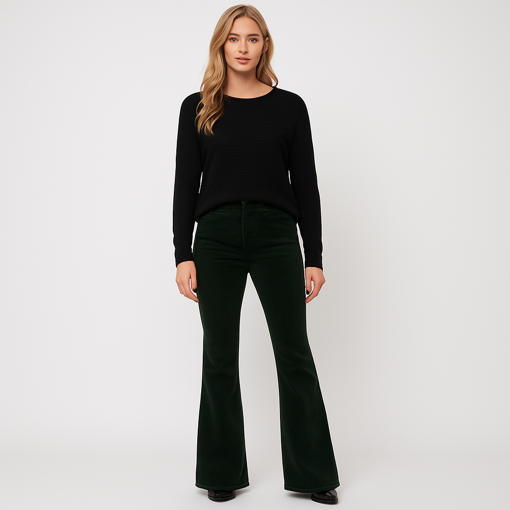 Corduroy flare pants styled with a relaxed sweater and heels for an effortlessly modern look.