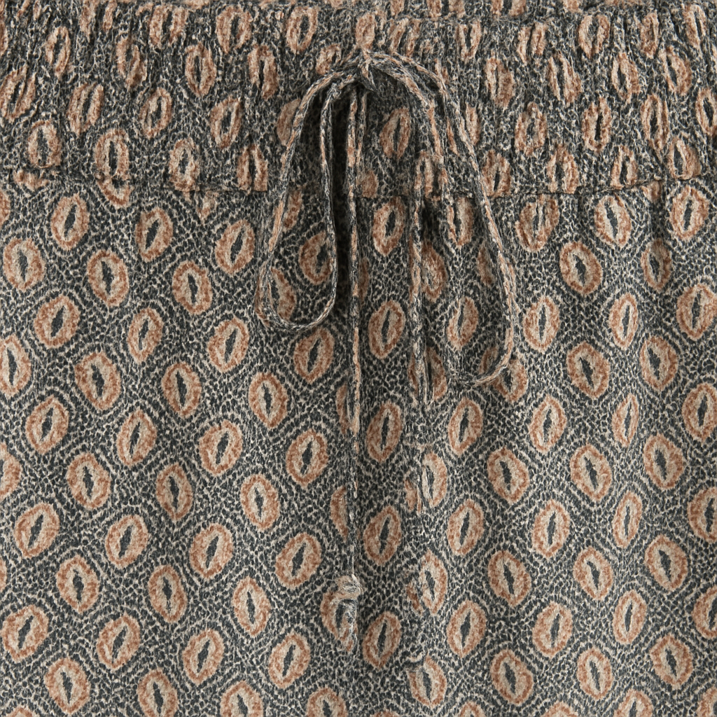 Flowy boho wide-leg pants with drawstring waistband and relaxed fit, styled for a casual summer look