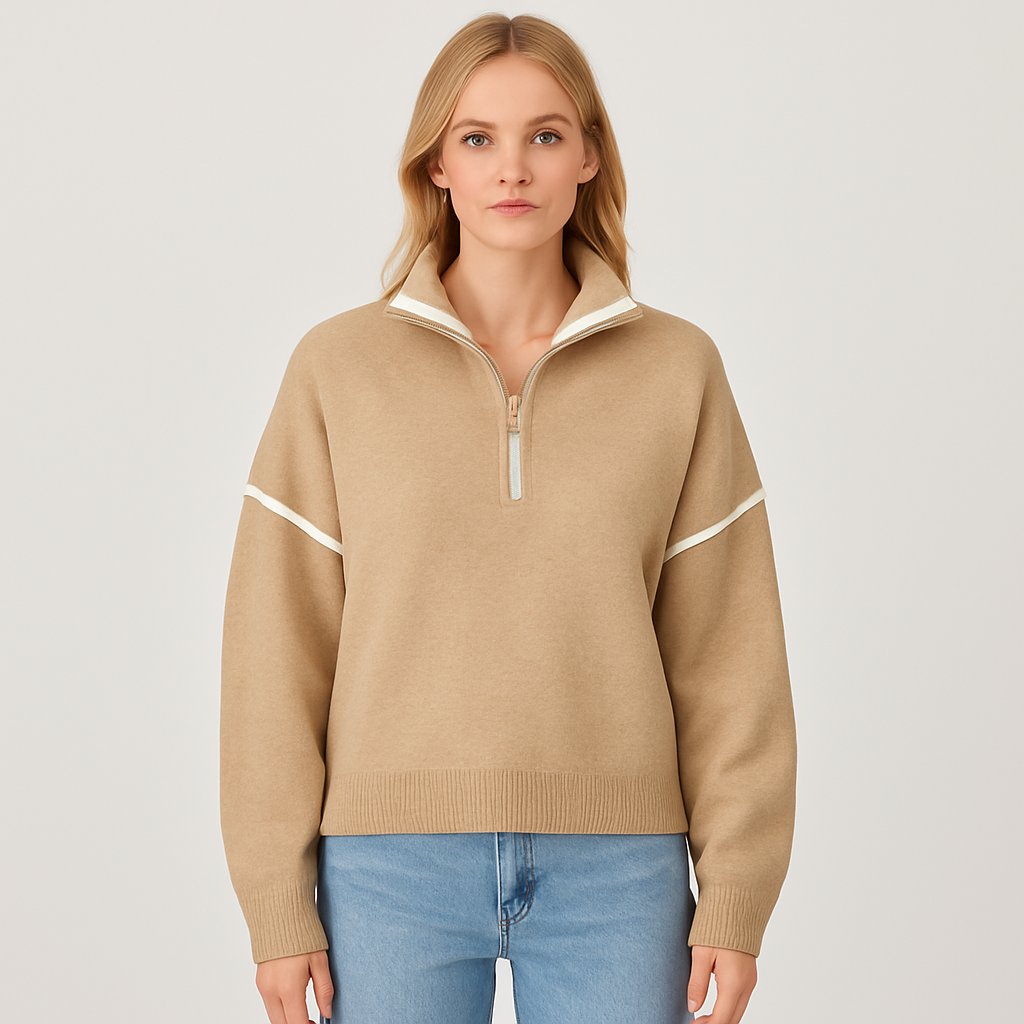A beige half-zip pullover sweater with white trim