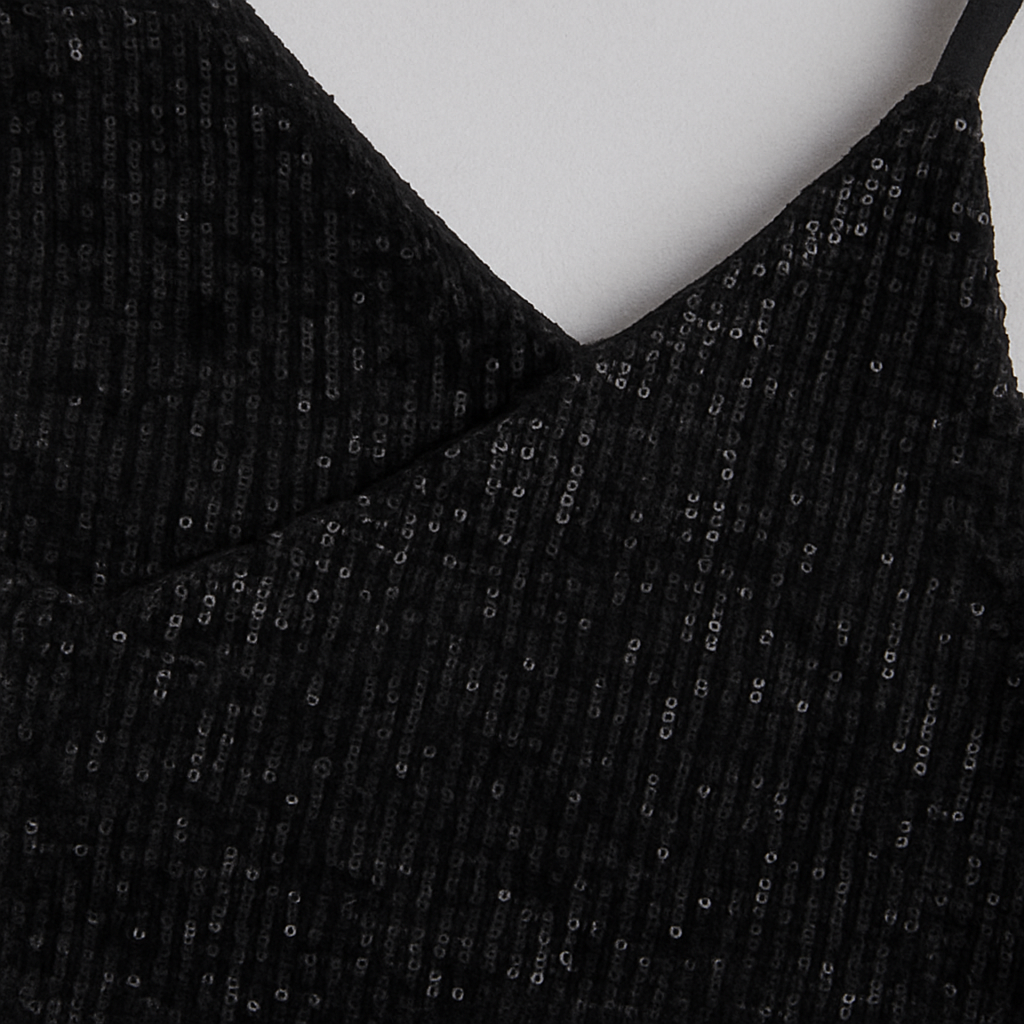 Sleeveless sequin mini dress with V-neckline, relaxed fit bodice, and gathered waist.