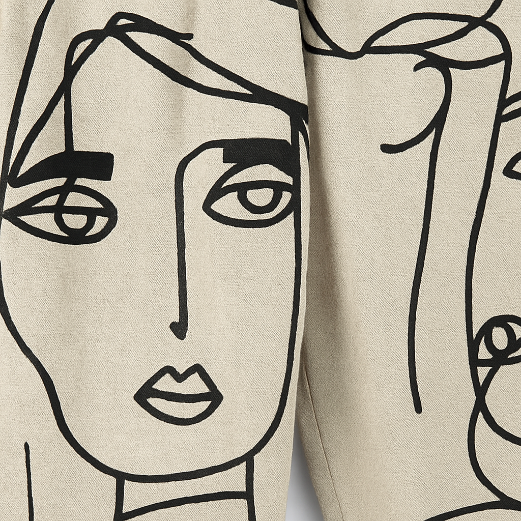 Cropped tapered pants with abstract face line-art print.