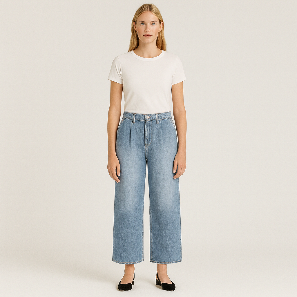 High-rise wide-leg denim jeans with front pleats and relaxed silhouette.