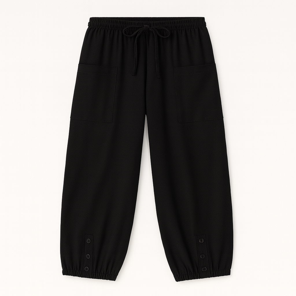 Relaxed jogger pants with elastic waistband, patch pockets, and buttoned hem details, styled for casual everyday wear