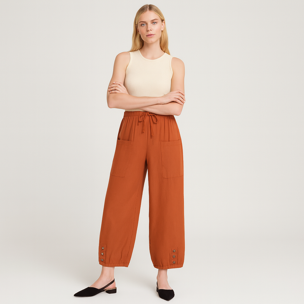 Relaxed jogger pants with elastic waistband, patch pockets, and buttoned hem details, styled for casual everyday wear