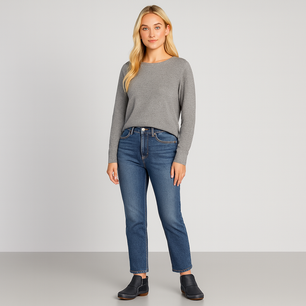 Ankle boot with slip-on design, contrast stitching, and flat sole.