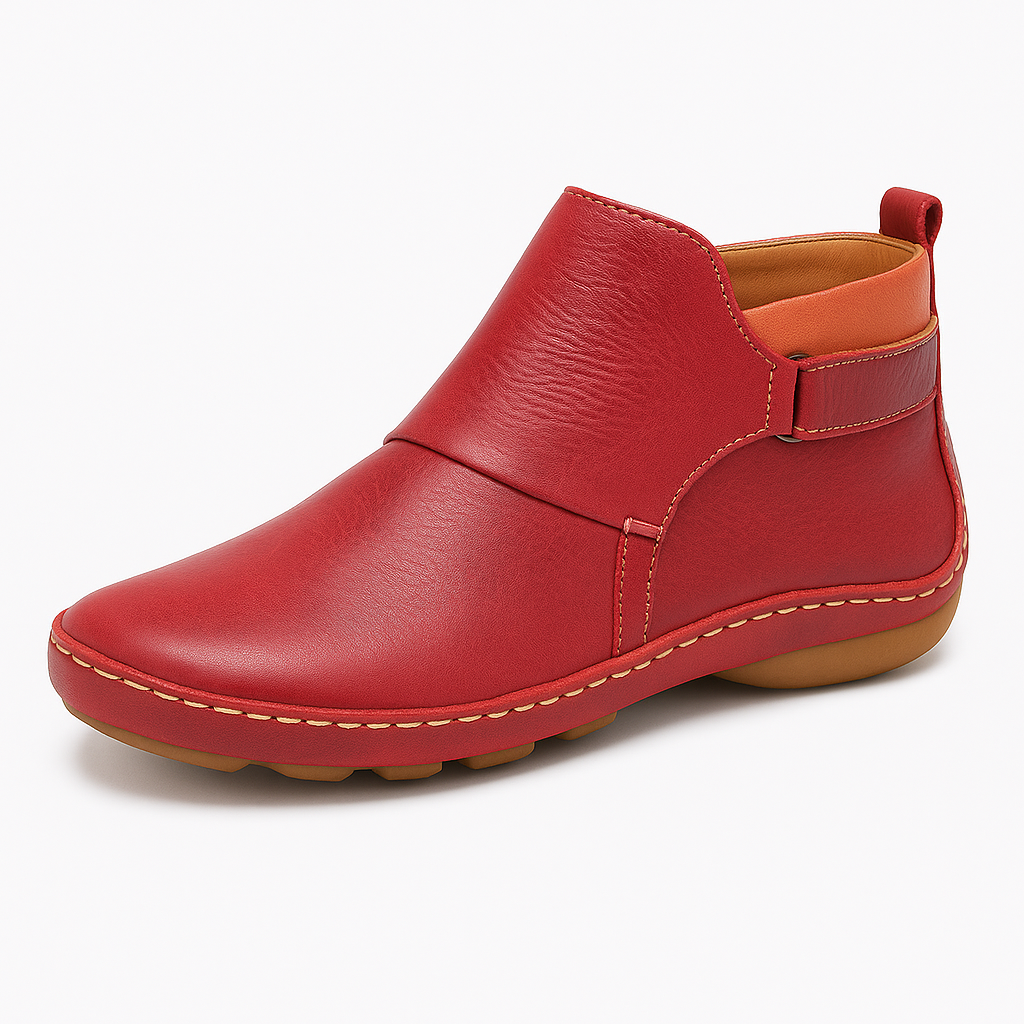 Ankle boot with slip-on design, contrast stitching, and flat sole.