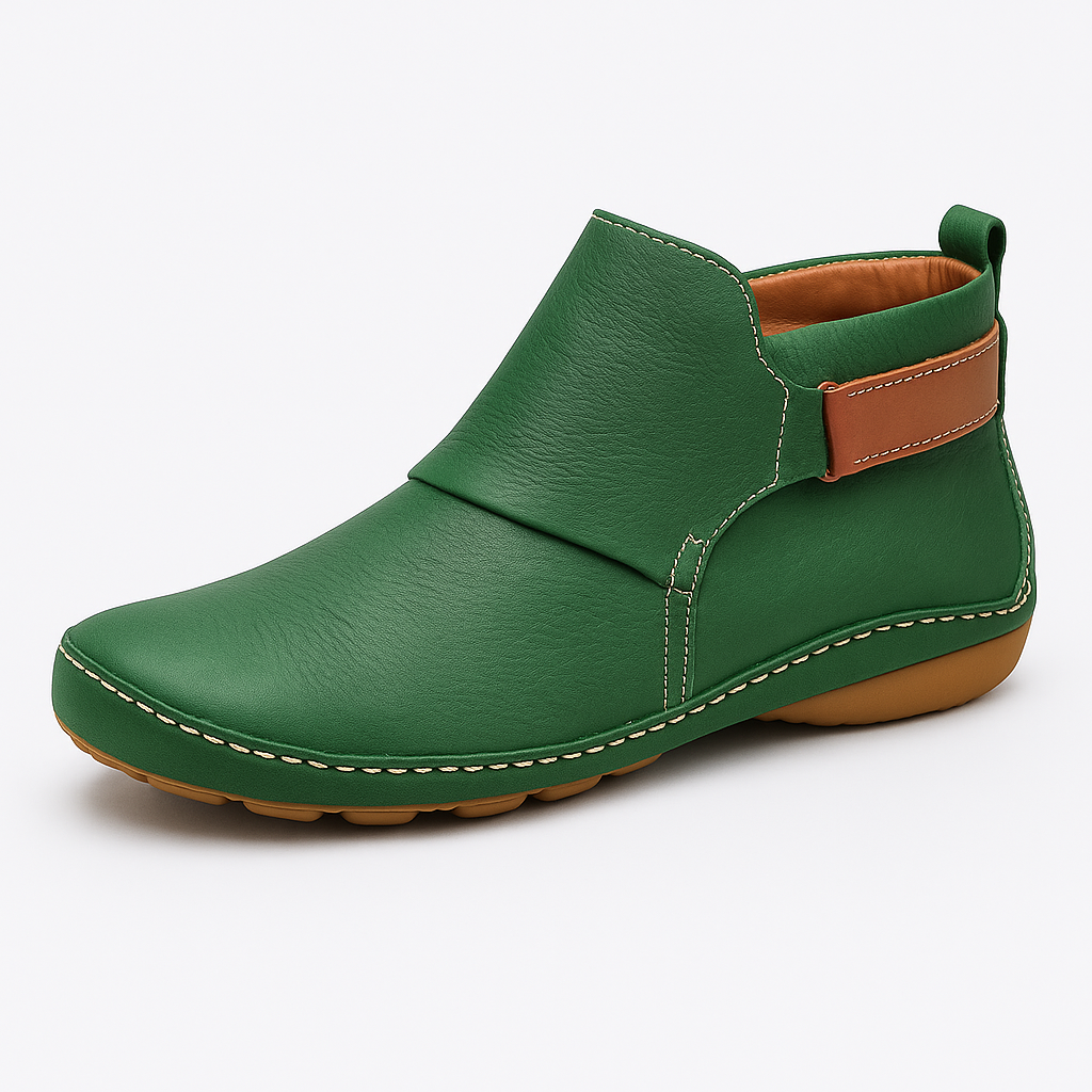 Ankle boot with slip-on design, contrast stitching, and flat sole.
