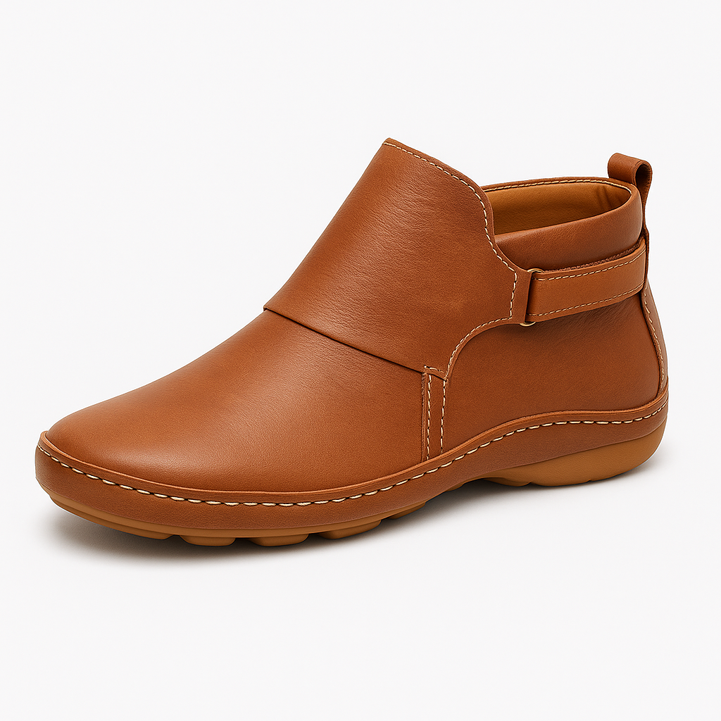 Ankle boot with slip-on design, contrast stitching, and flat sole.