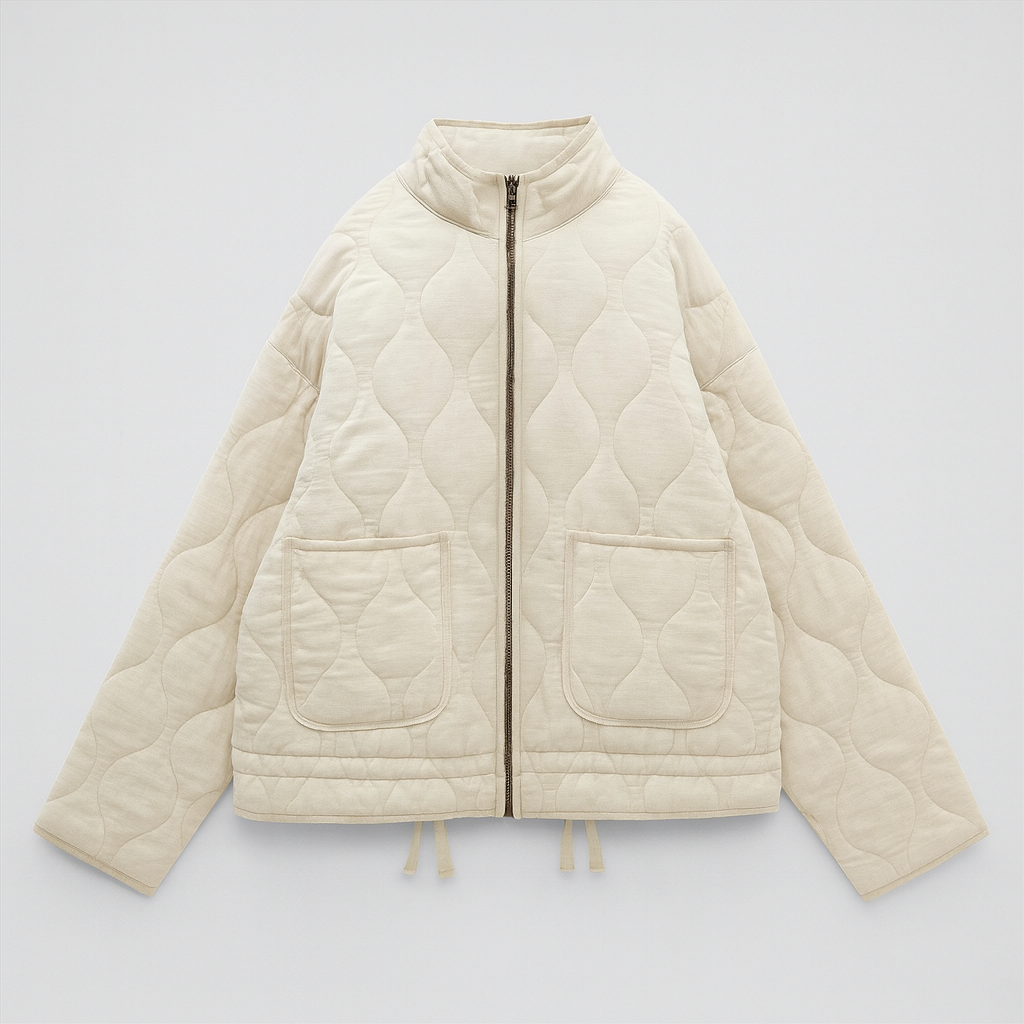 A quilted jacket featuring a high collar, full front zipper, and relaxed fit. Designed with wave-pattern stitching, two large front patch pockets, and adjustable drawstrings at the hem for a customizable fit. A minimalist yet functional outerwear piece perfect for layering in cooler weather.