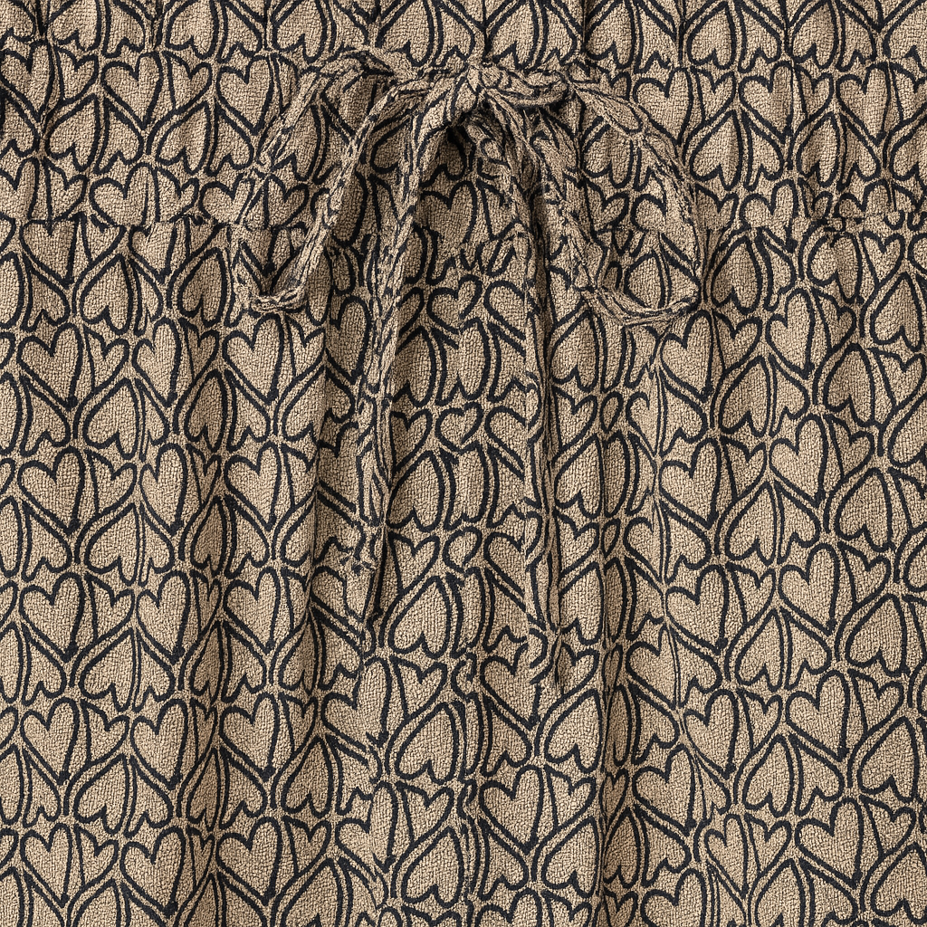 Wide-leg patterned pants with elastic waistband and drawstring tie.