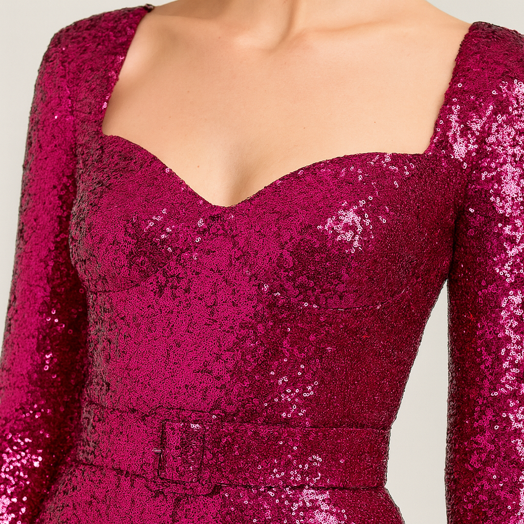 Sequin jumpsuit with long sleeves, sweetheart neckline, fitted waist with matching belt, and flared legs.