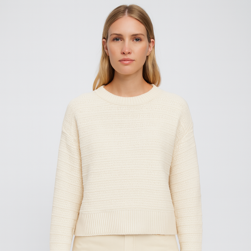 A cream knit sweater with subtle horizontal textured stripes