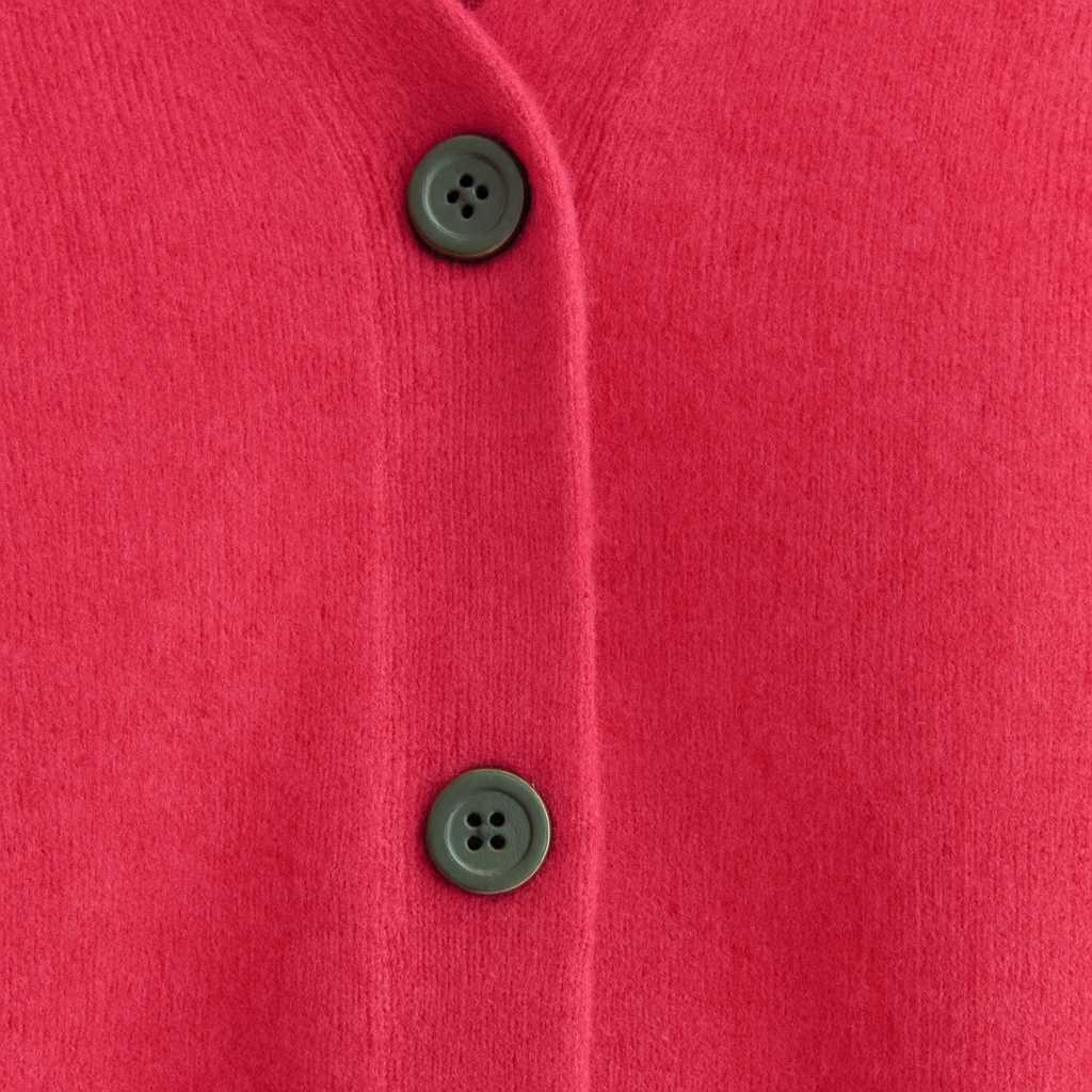 A plain knitted cardigan with a V-neckline, long sleeves, and front button closure.