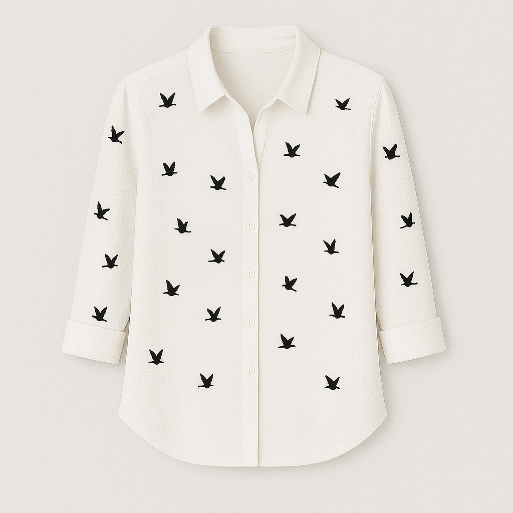 Button-up blouse with black bird print pattern, collared neckline, and 3/4 rolled sleeves.